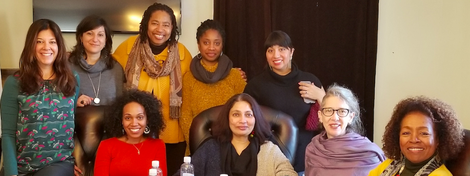 Nine women, four sitting and 5 standing.